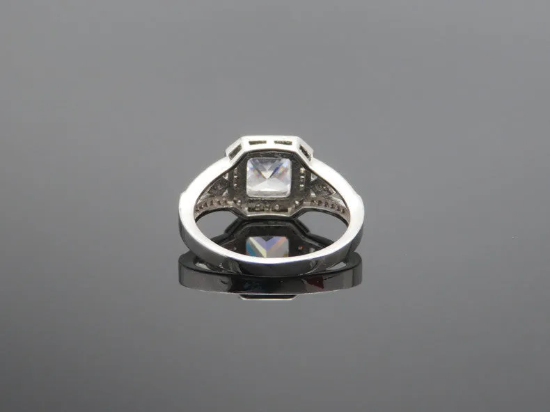 Geometric hollow design women's zircon ring in platinum finish on copper, showing quadrilateral stone.
