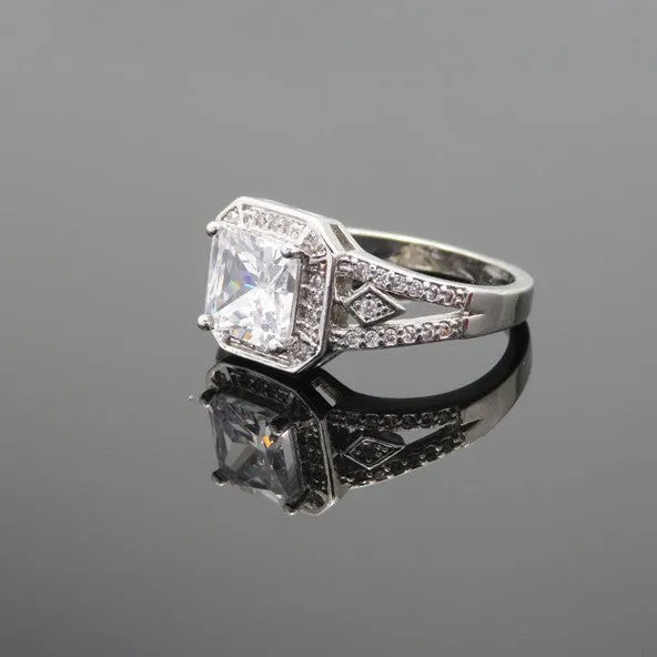 Geometric hollow design women's zircon ring in platinum finish on copper, showing quadrilateral stone.