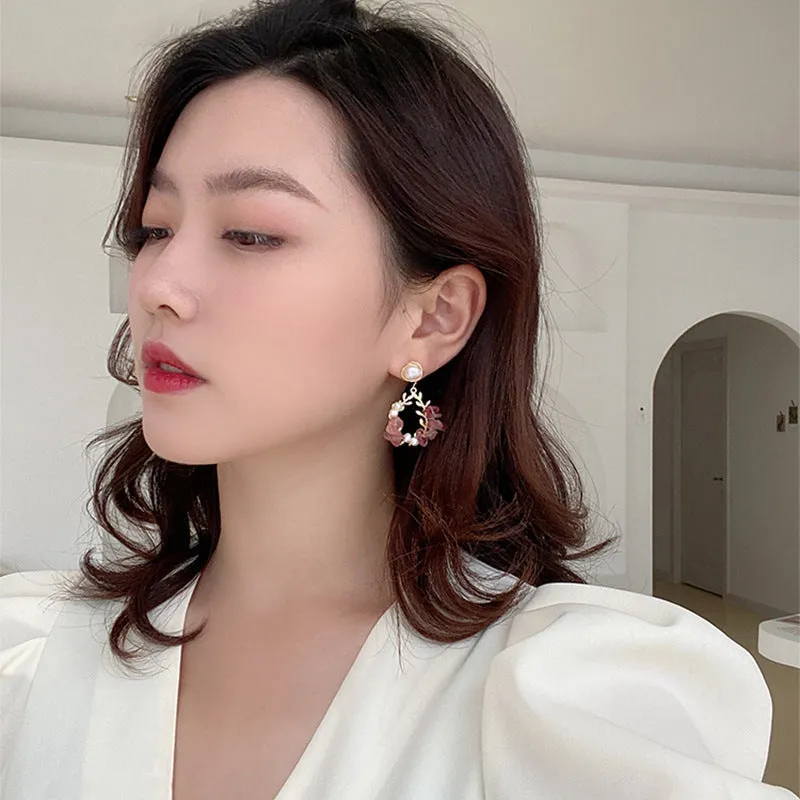 Pink crystal leaf design earrings with silver plated finish on alloy base