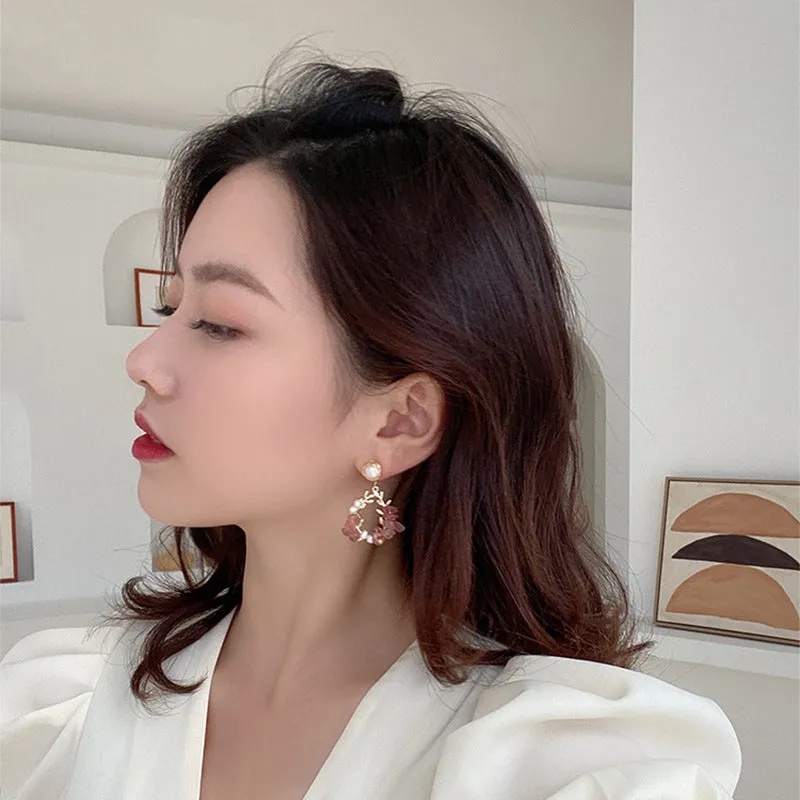 Pink crystal leaf design earrings with silver plated finish on alloy base