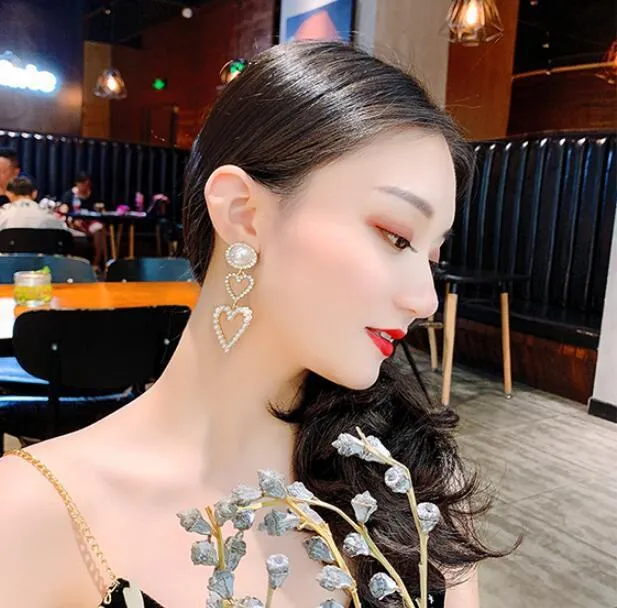 Pair of gold pearl rhinestone drop earrings on a plain background, measuring 7x2.5cm