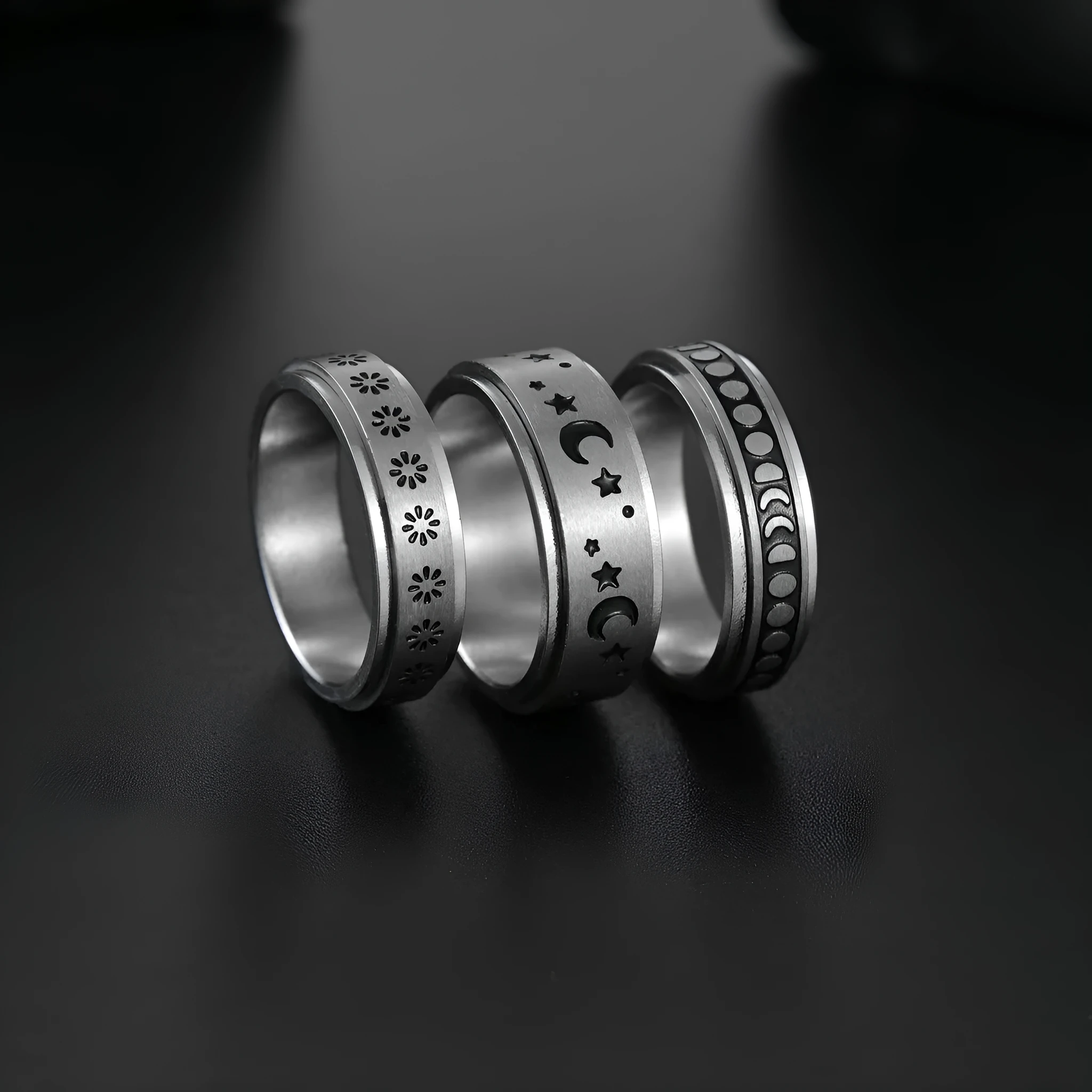 Titanium steel star moon ring in glossy finish on a neutral background, showing celestial motif and band width