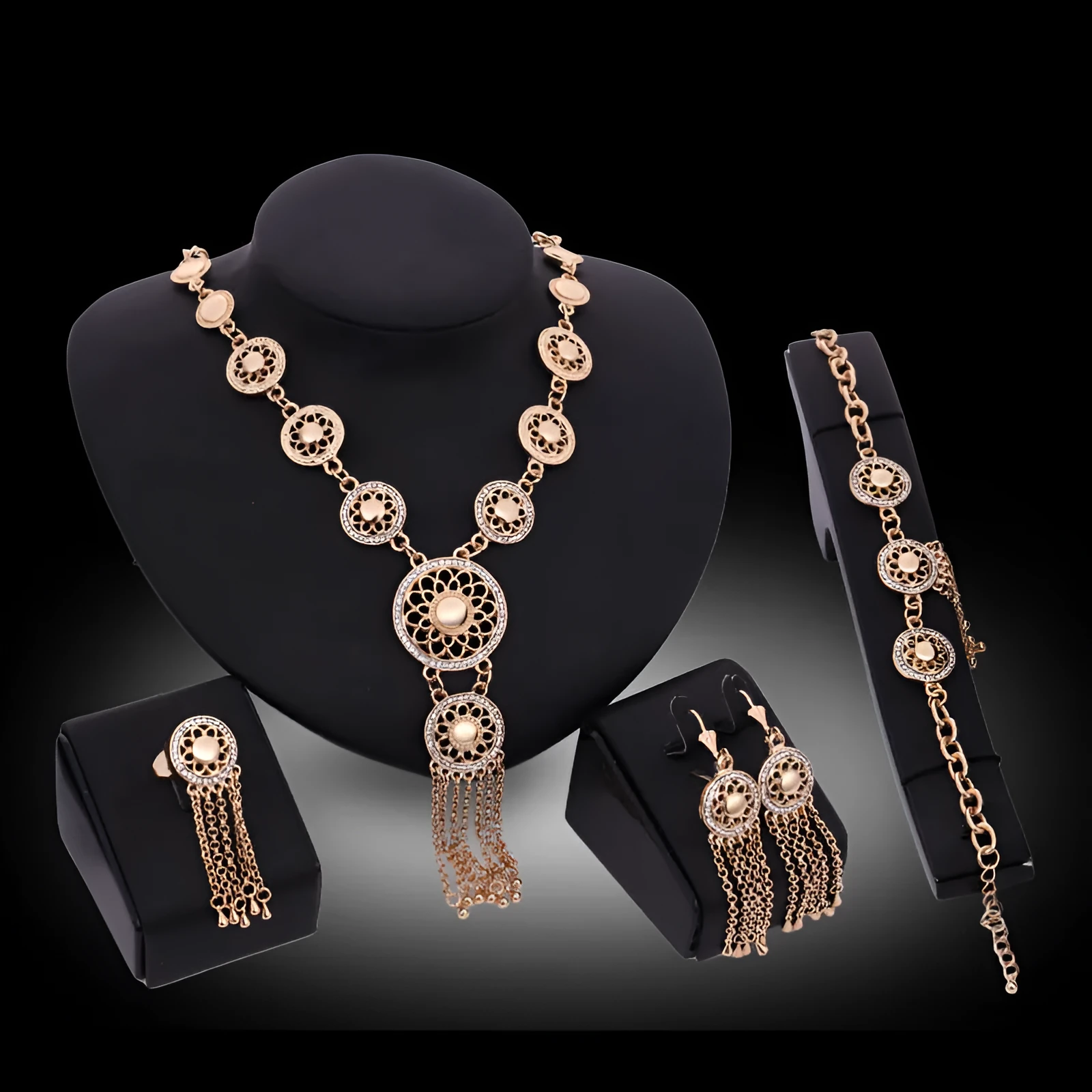 Gold alloy jewellery set with earrings, necklace, and bracelet featuring star and celestial pattern on a light background
