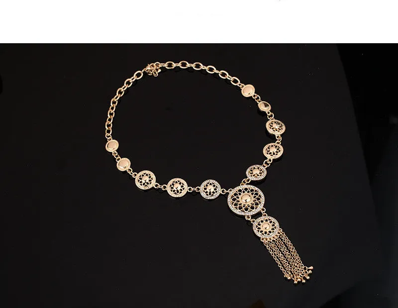 Gold alloy jewellery set with earrings, necklace, and bracelet featuring star and celestial pattern on a light background