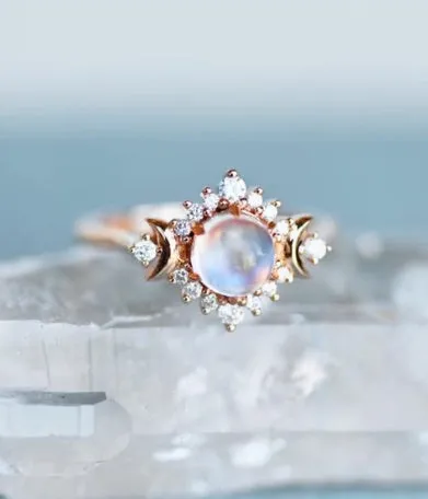 Five stackable fashion rings in gold and rose gold finishes on a white background