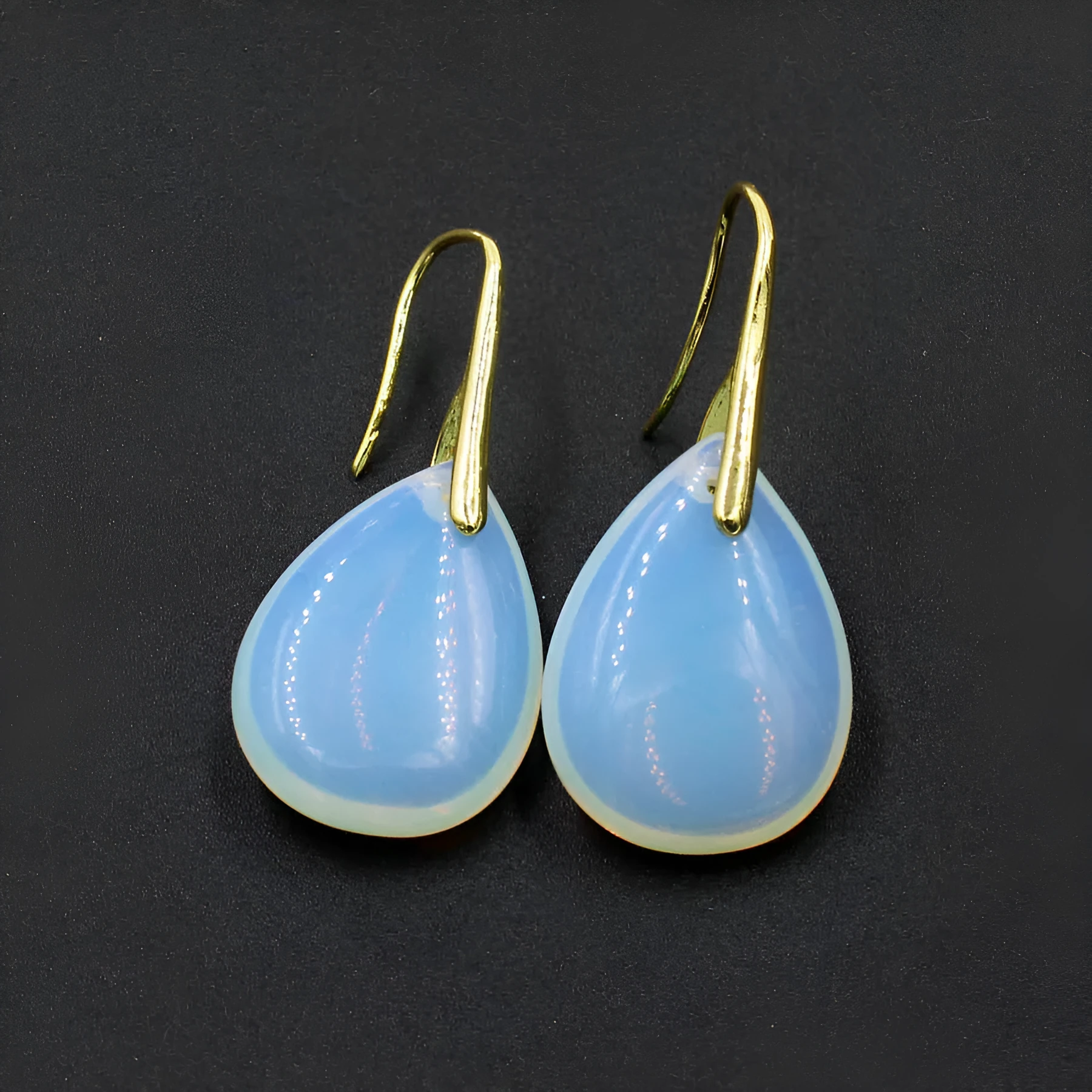A pair of geometric water drop shaped earrings made from crystal in an electroplated finish.