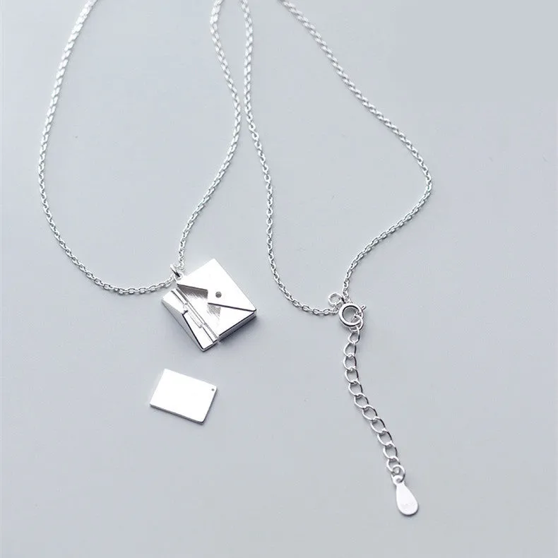Titanium steel envelope pendant necklace with chain on a woman's neck, gold finish