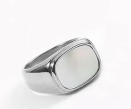 Silver white fashion ring with glossy finish and simulated diamond centre stone on light background