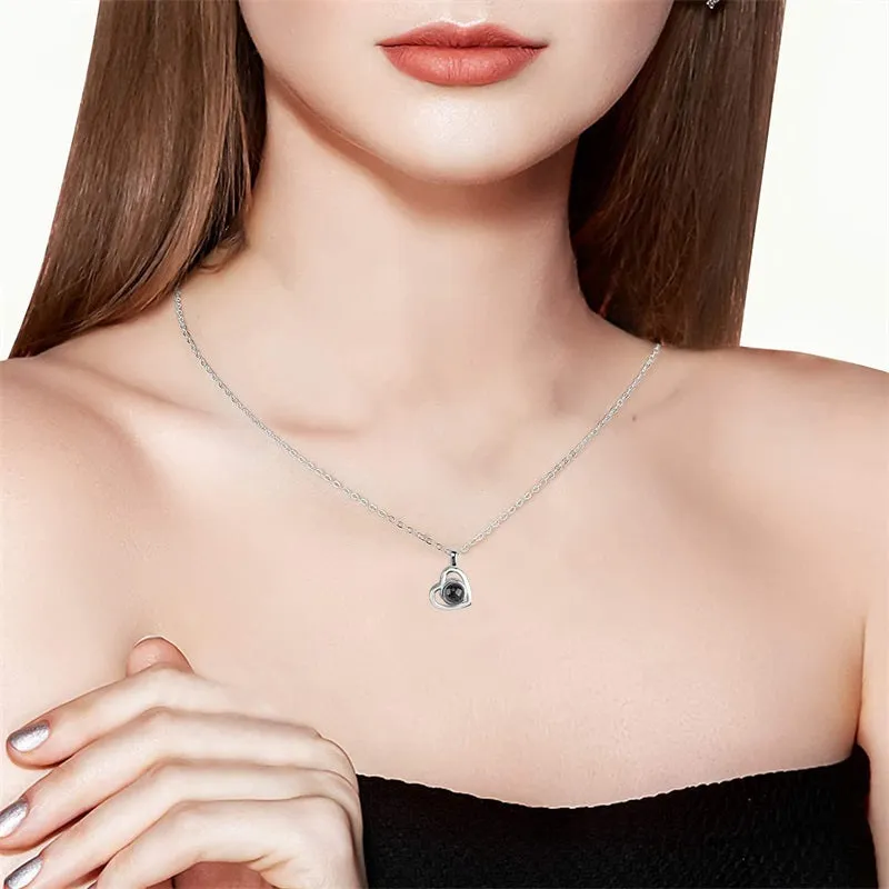 100 Languages I Love You necklace with heart-shaped charm showing custom photo projection inside, in gold finish