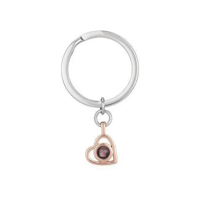 100 Languages I Love You necklace with heart-shaped charm showing custom photo projection inside, in gold finish