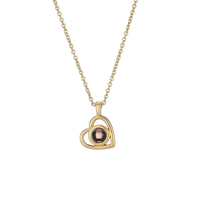 100 Languages I Love You necklace with heart-shaped charm showing custom photo projection inside, in gold finish