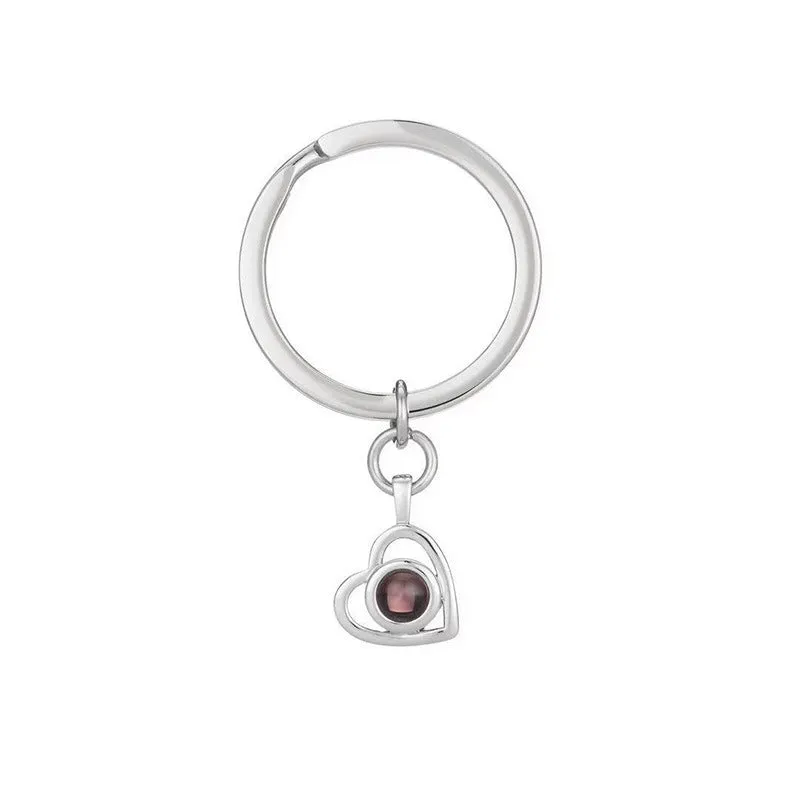100 Languages I Love You necklace with heart-shaped charm showing custom photo projection inside, in gold finish