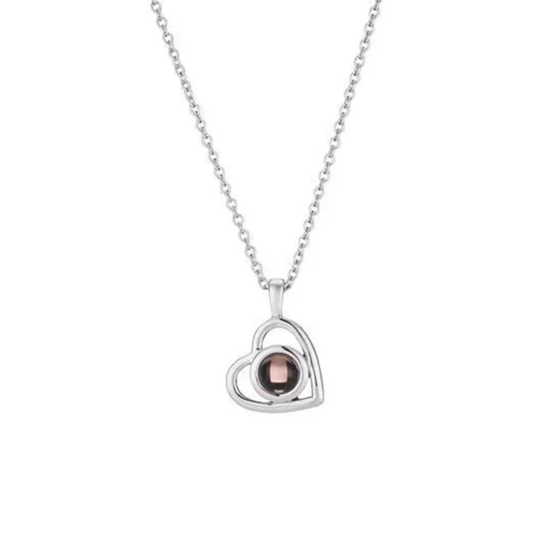 100 Languages I Love You necklace with heart-shaped charm showing custom photo projection inside, in gold finish
