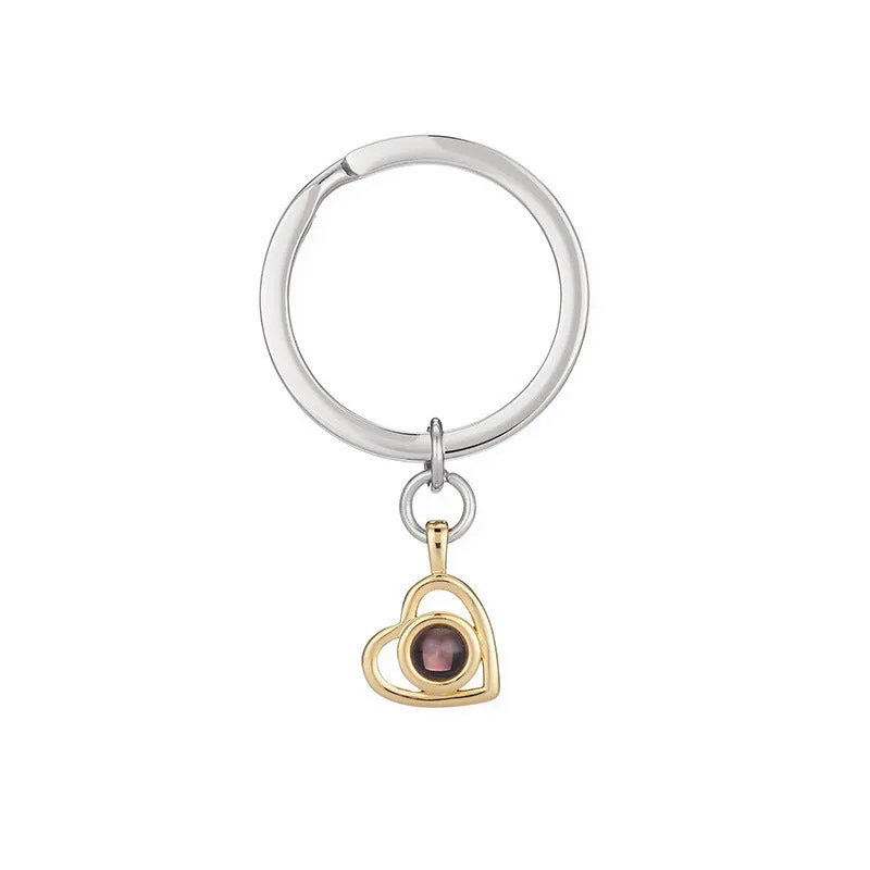 100 Languages I Love You necklace with heart-shaped charm showing custom photo projection inside, in gold finish