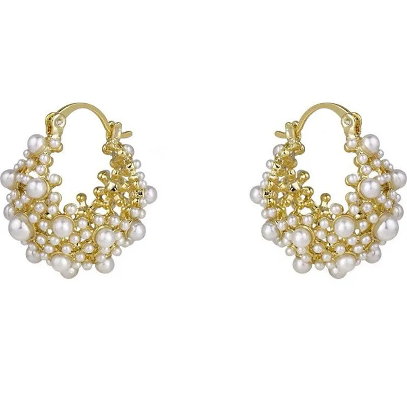 Gold-coloured copper flower basket earrings with small rice-shaped beads and pearl inlay detailing.