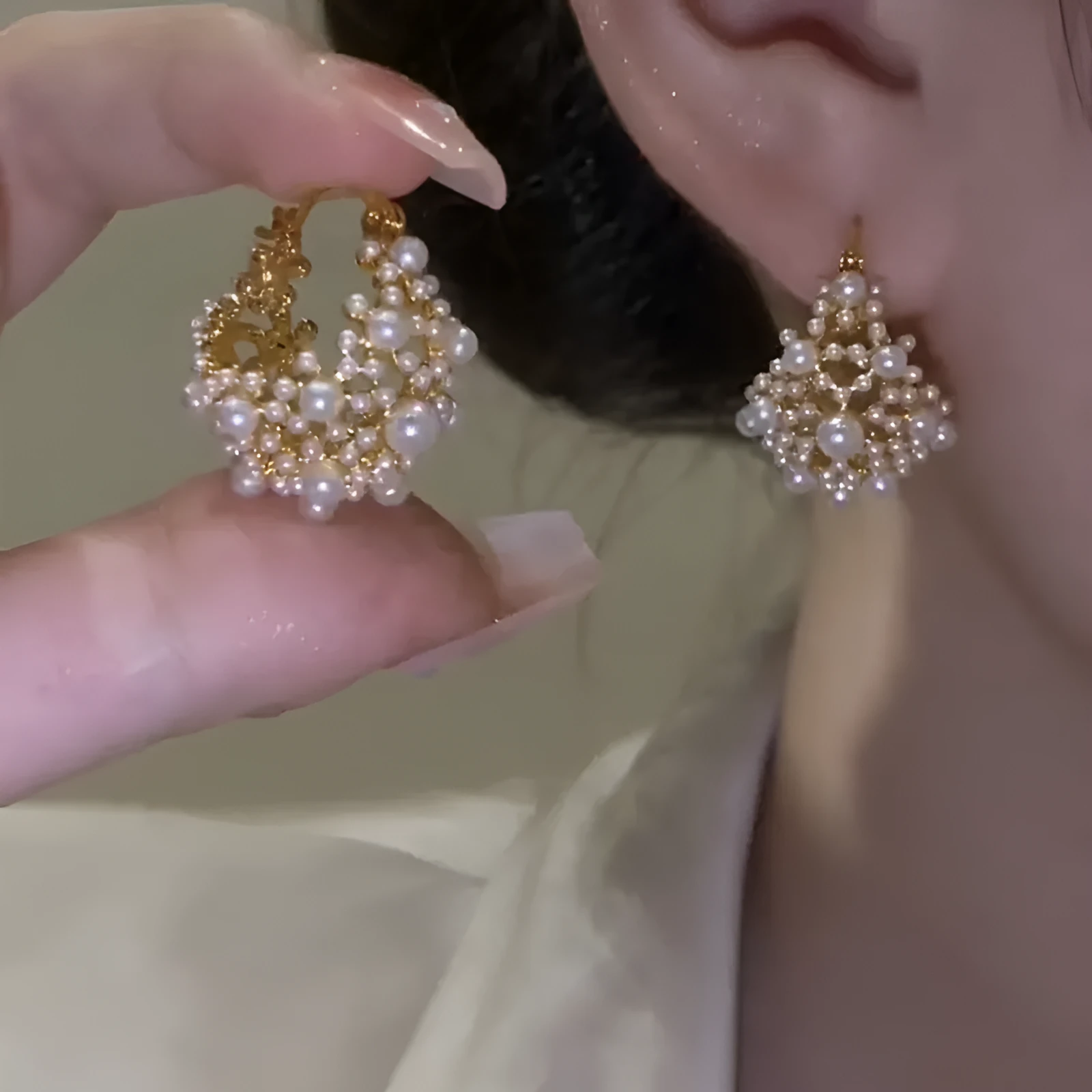 Gold-coloured copper flower basket earrings with small rice-shaped beads and pearl inlay detailing.