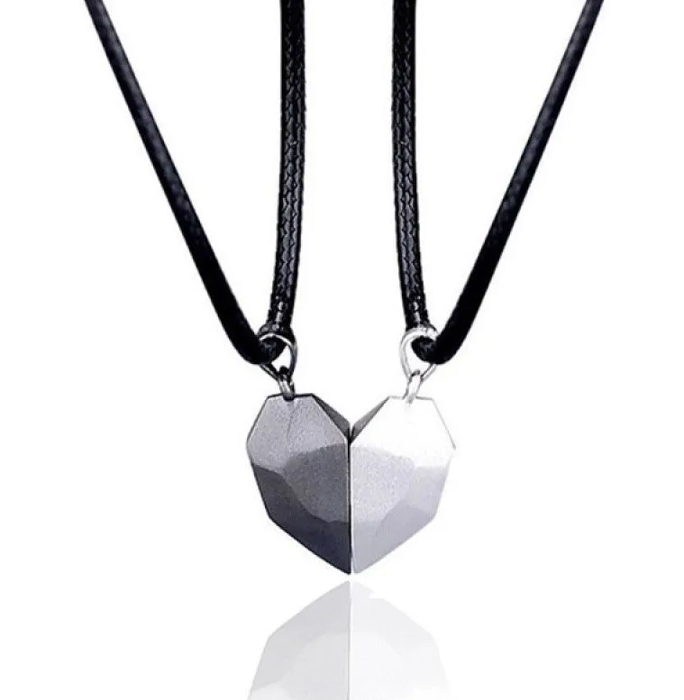 Gold-plated magnetic faceted heart pendant necklace in black and white on display