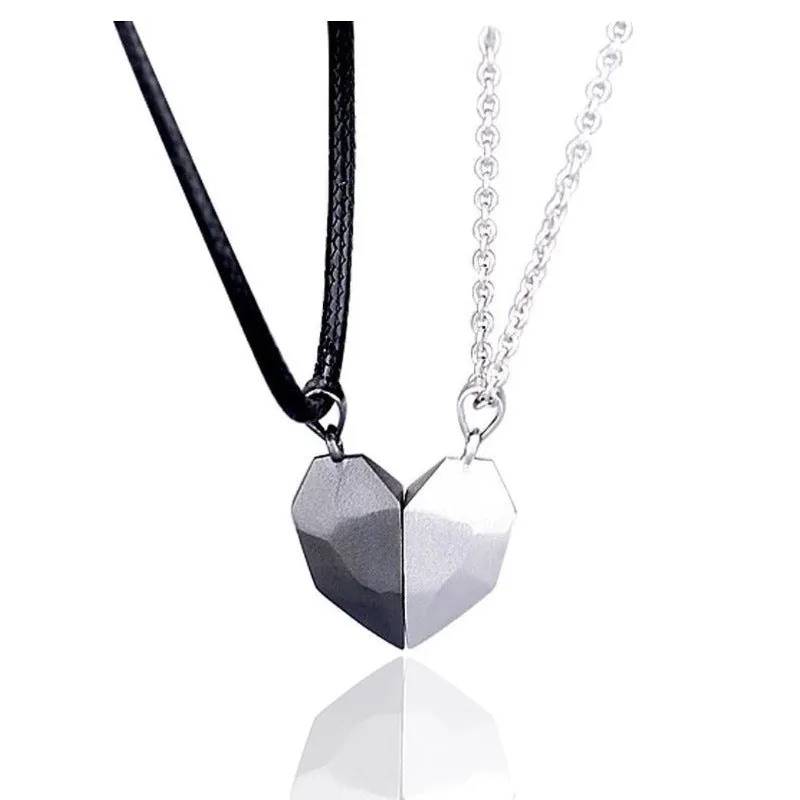Gold-plated magnetic faceted heart pendant necklace in black and white on display