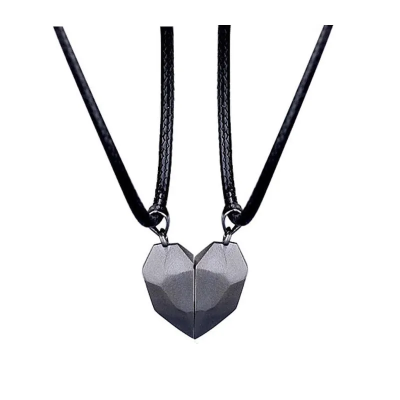 Gold-plated magnetic faceted heart pendant necklace in black and white on display