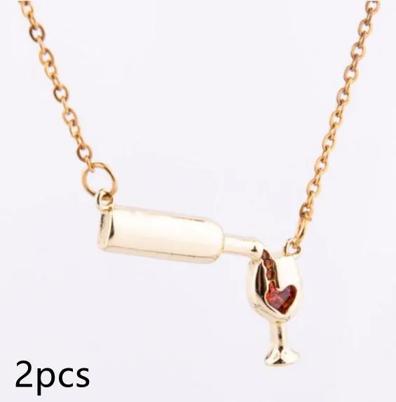 Gold alloy wine bottle and glass pendant necklace on a light background