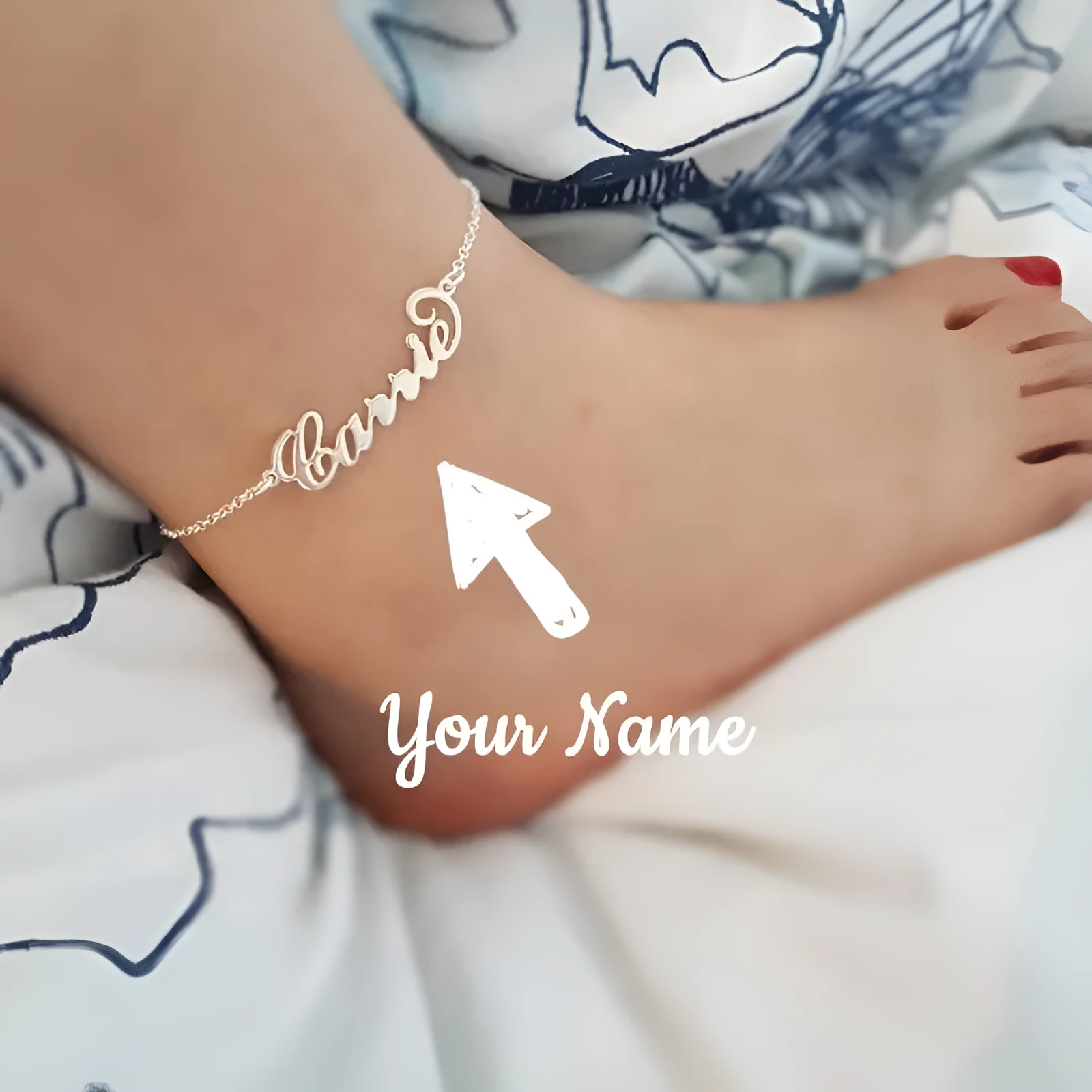 Gold titanium steel cable chain anklet with personalised name engraving on a sandy beach background