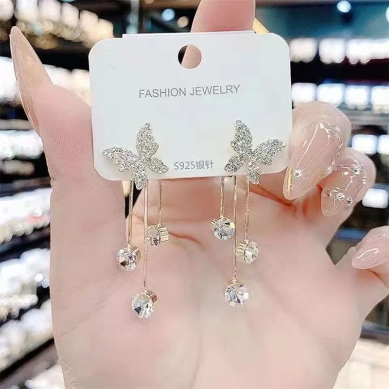 Silver butterfly rhinestone drop dangle earrings with pearl tassel chain and heart elements on alloy