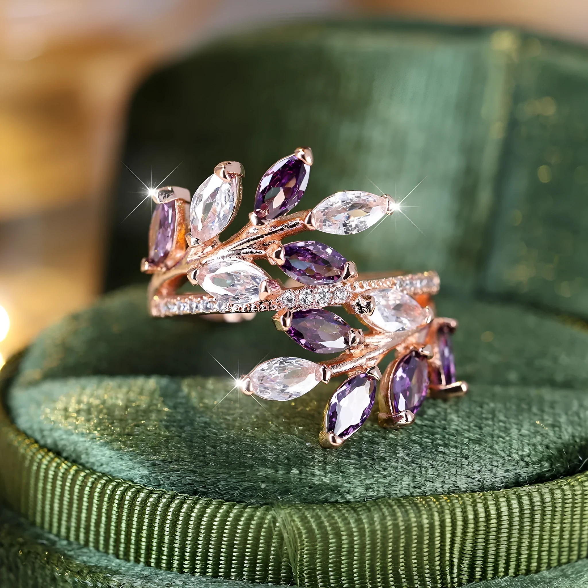 Adjustable copper leaf fashion ring with a central zircon stone on a model's hand, showing rose gold and platinum colour variants.
