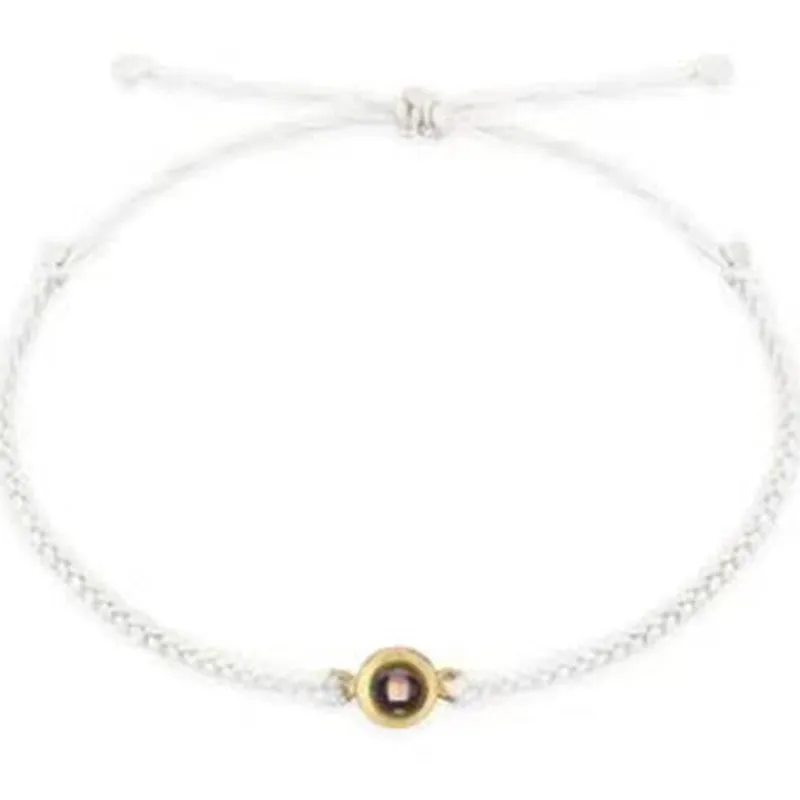 Personalised photo projection bracelet in copper with gold rope, showing unisex geometric shape