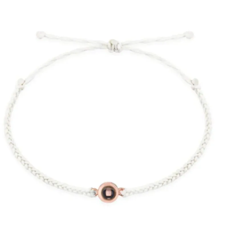 Personalised photo projection bracelet in copper with gold rope, showing unisex geometric shape