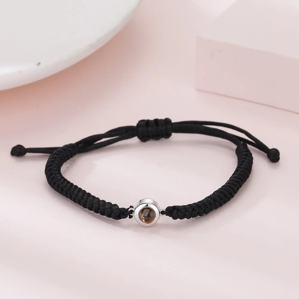 Personalised photo projection bracelet in copper with gold rope, showing unisex geometric shape