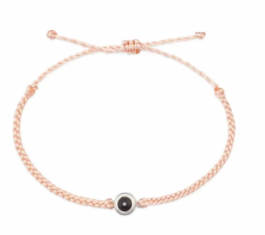 Personalised photo projection bracelet in copper with gold rope, showing unisex geometric shape