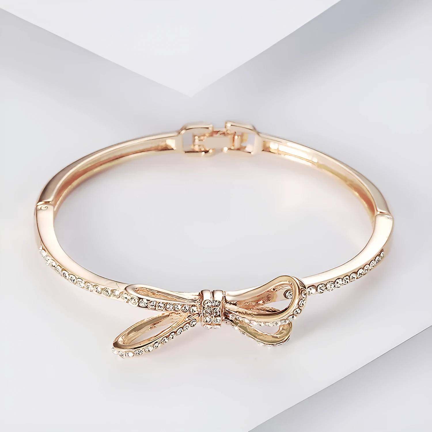 Rose gold electroplated copper women's bracelet with bow and diamond accents