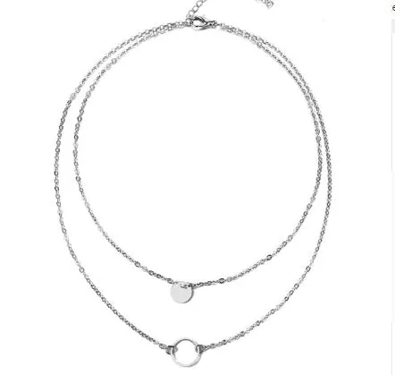 Gold multi-layer sequined choker necklace with drop pendant on woman's neck