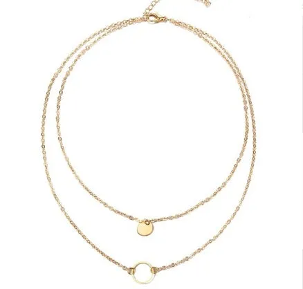 Gold multi-layer sequined choker necklace with drop pendant on woman's neck