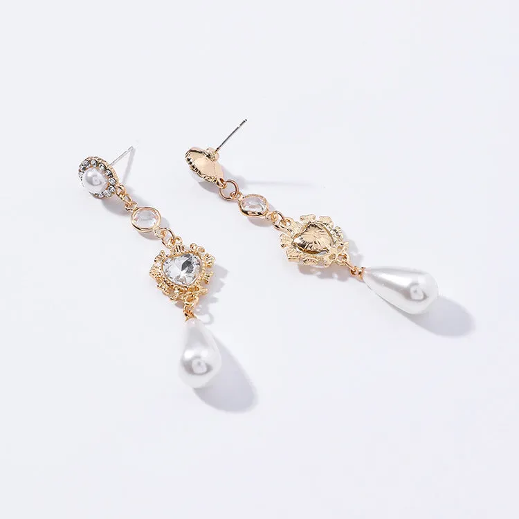 Gold pearl drop earrings with heart-shaped alloy frame and single pearl pendant on gold-tone finish