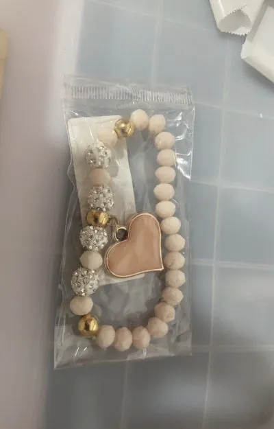 Elastic crystal bracelet and bangle heart bracelet in pink colour on white background