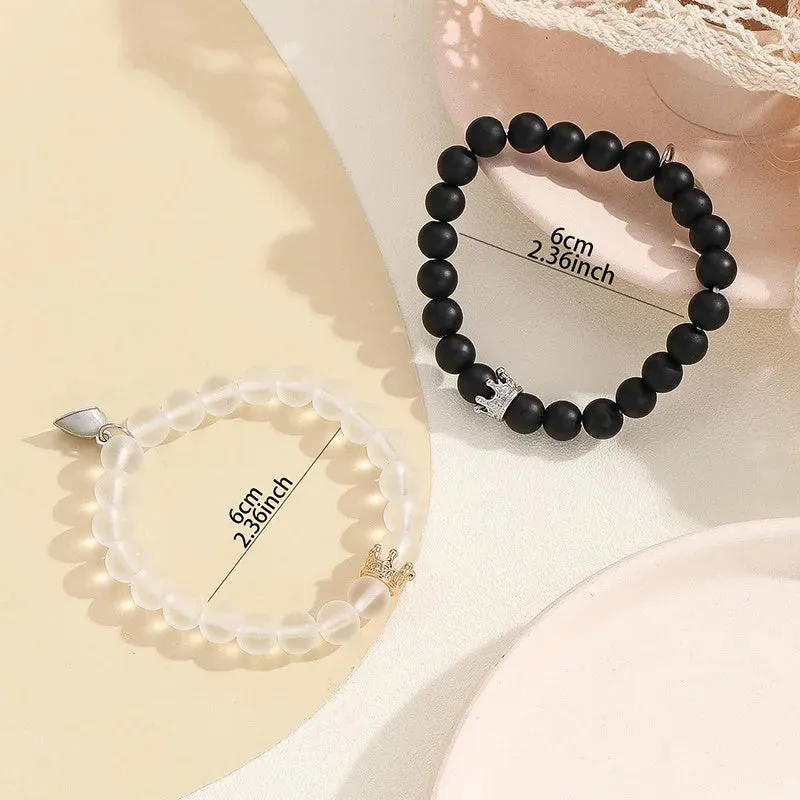 2pcs handmade glow-in-the-dark crown beaded bracelets in white and black with glass beads and luminous heart charm