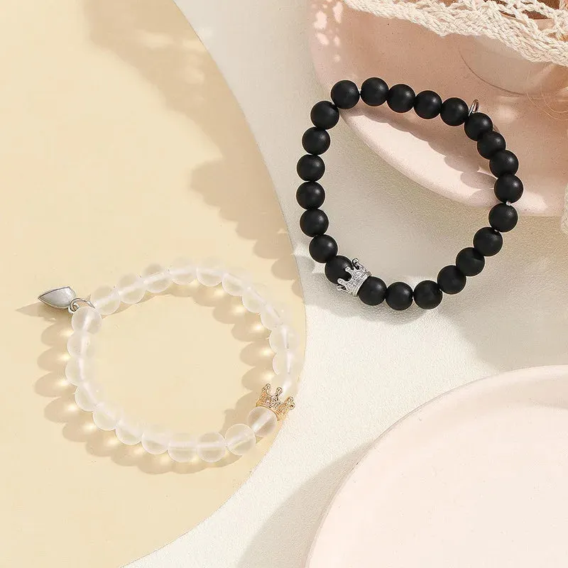 2pcs handmade glow-in-the-dark crown beaded bracelets in white and black with glass beads and luminous heart charm