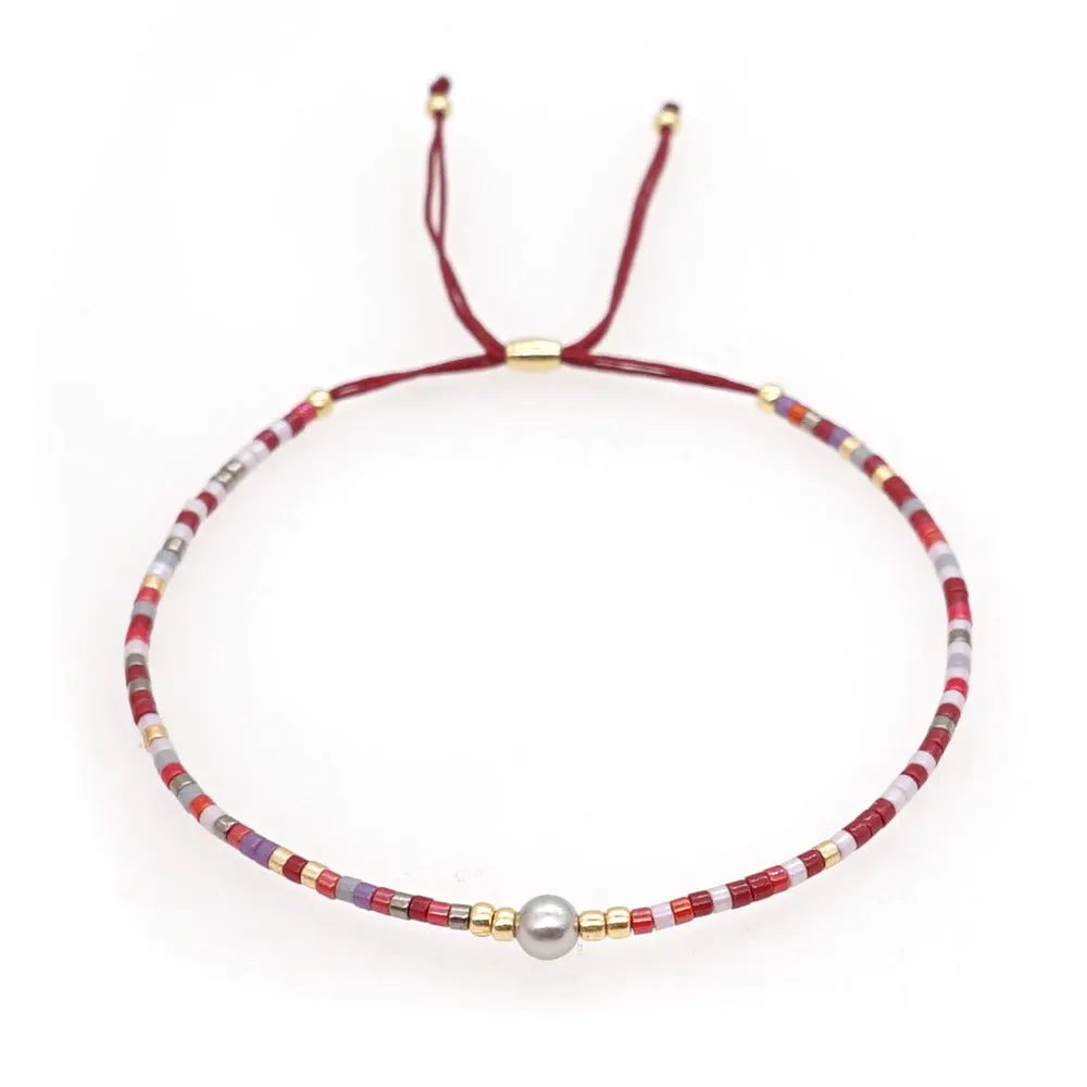 Handmade colourful beaded bracelet with geometric glass and glaze beads in bohemian style
