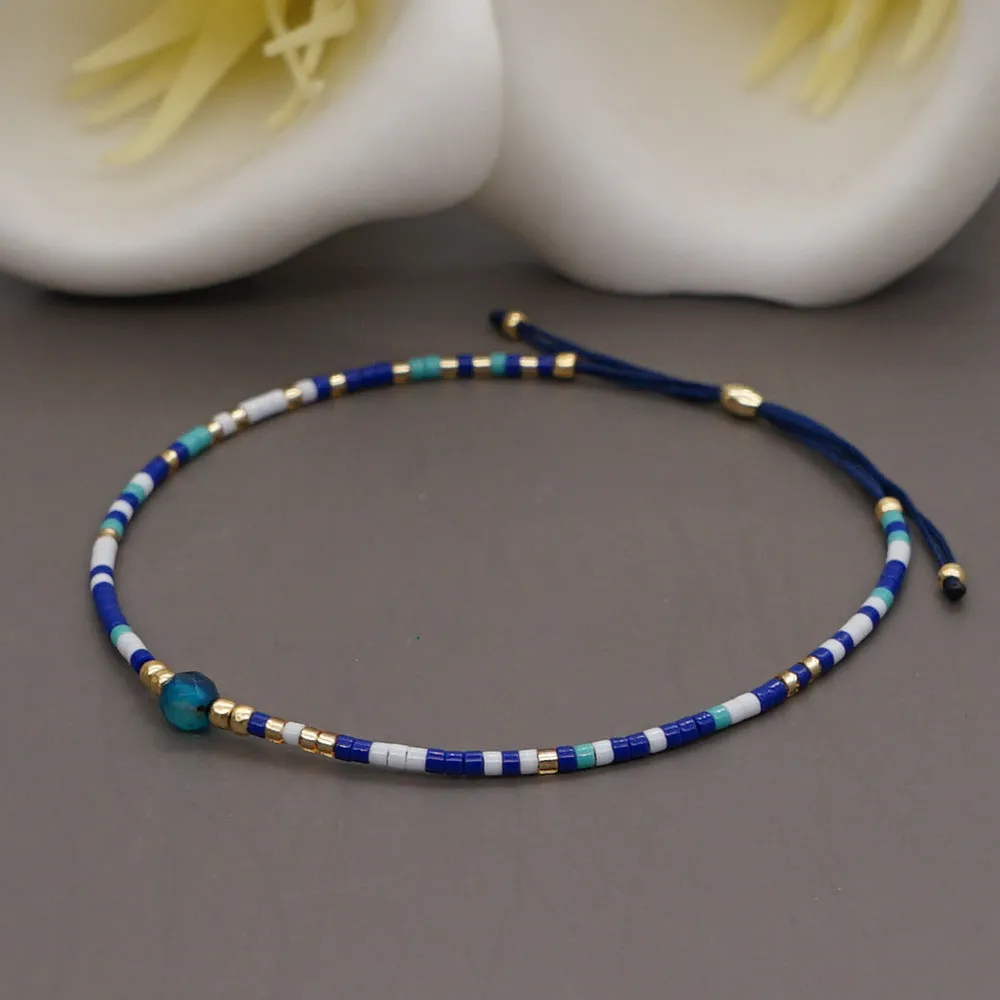 Handmade colourful beaded bracelet with geometric glass and glaze beads in bohemian style