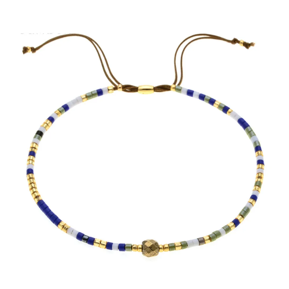 Handmade colourful beaded bracelet with geometric glass and glaze beads in bohemian style