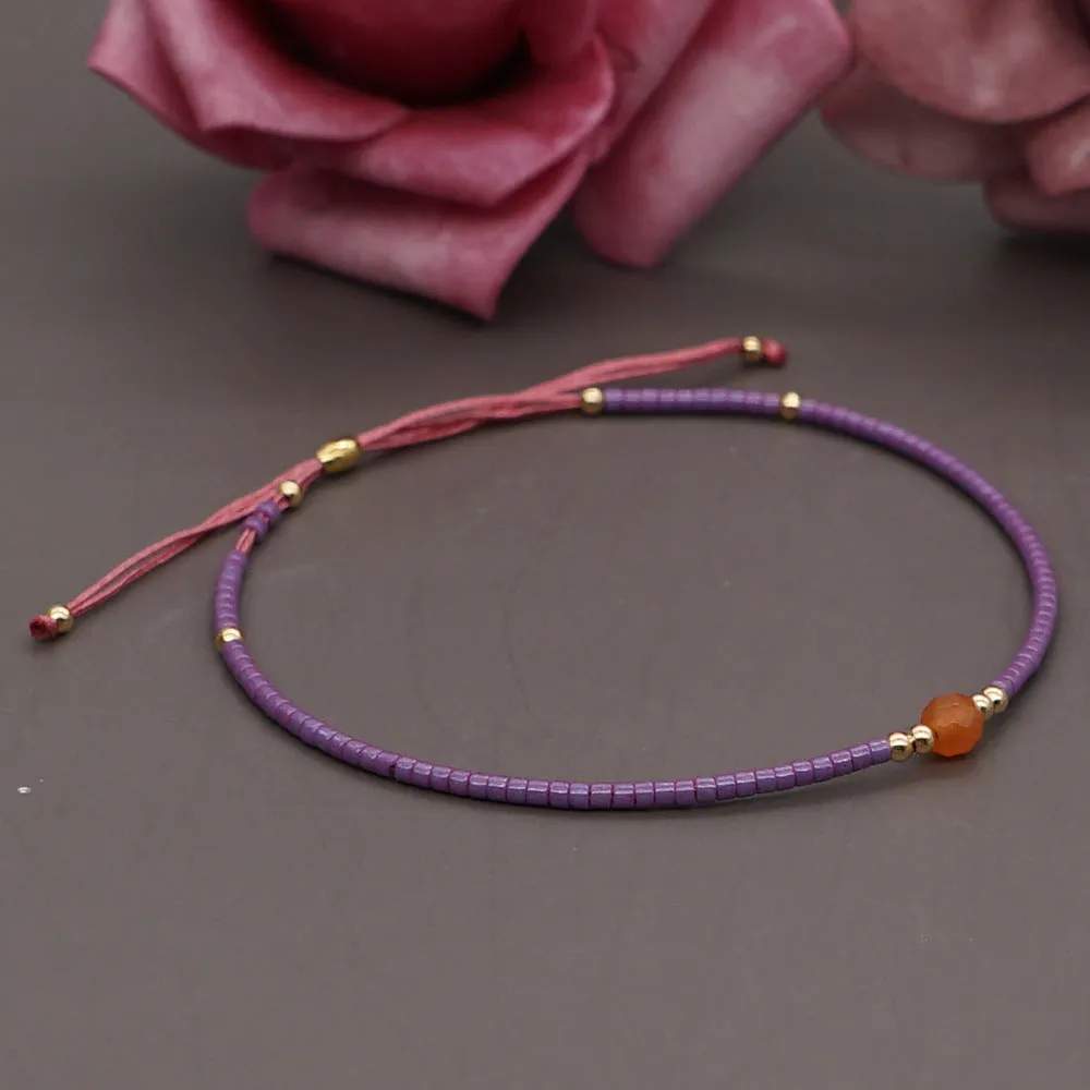 Handmade colourful beaded bracelet with geometric glass and glaze beads in bohemian style