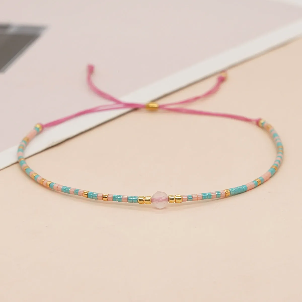 Handmade colourful beaded bracelet with geometric glass and glaze beads in bohemian style