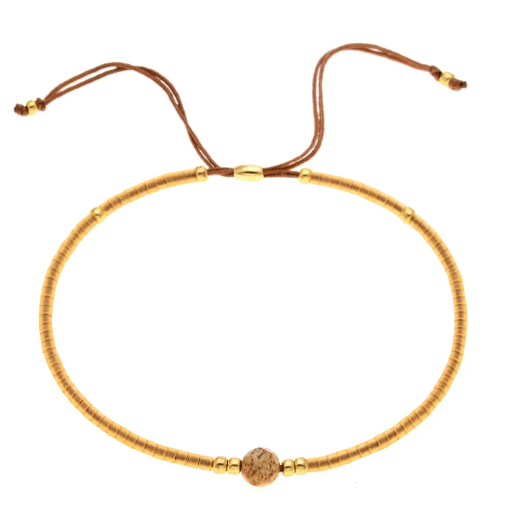 Handmade colourful beaded bracelet with geometric glass and glaze beads in bohemian style