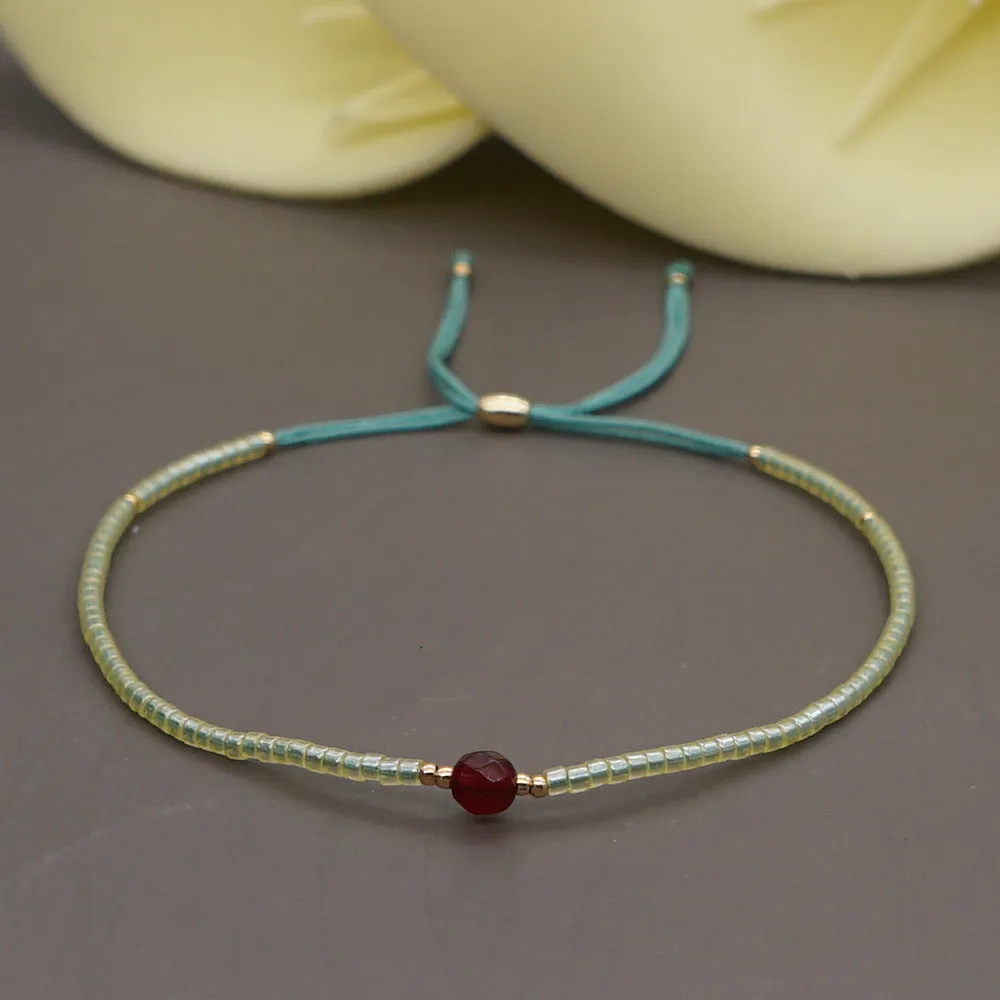 Handmade colourful beaded bracelet with geometric glass and glaze beads in bohemian style