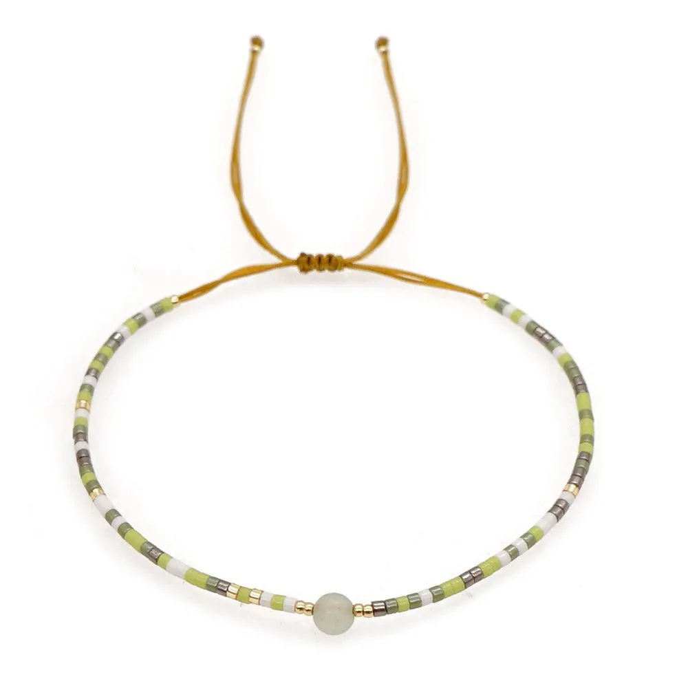 Handmade colourful beaded bracelet with geometric glass and glaze beads in bohemian style