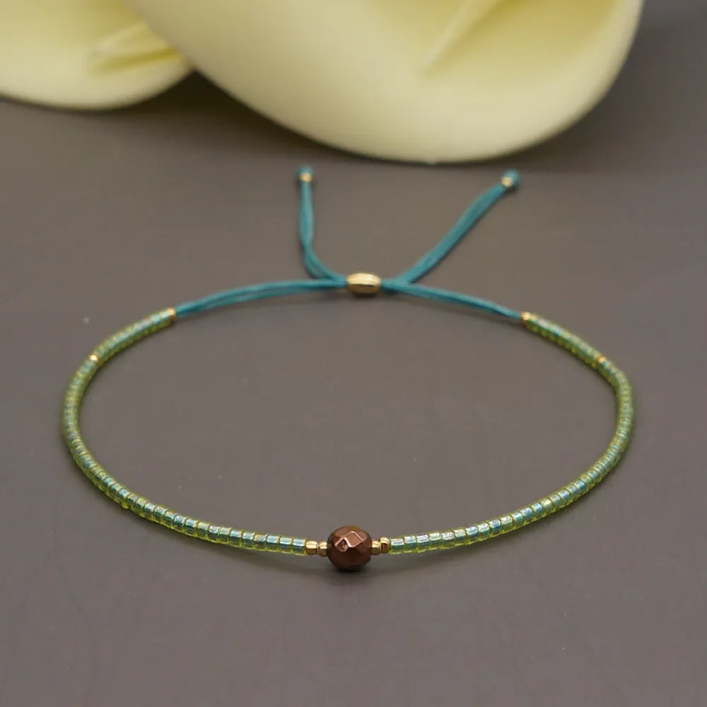 Handmade colourful beaded bracelet with geometric glass and glaze beads in bohemian style