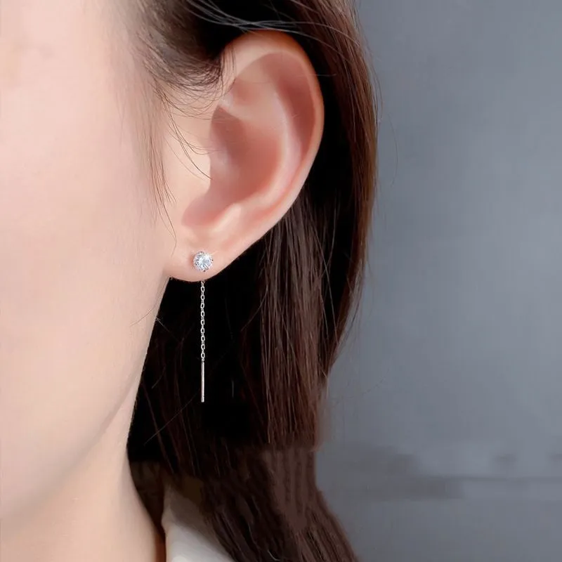 Round zirconium stud earrings with tassel rhinestone hanging in white gold colour on a geometric silver base