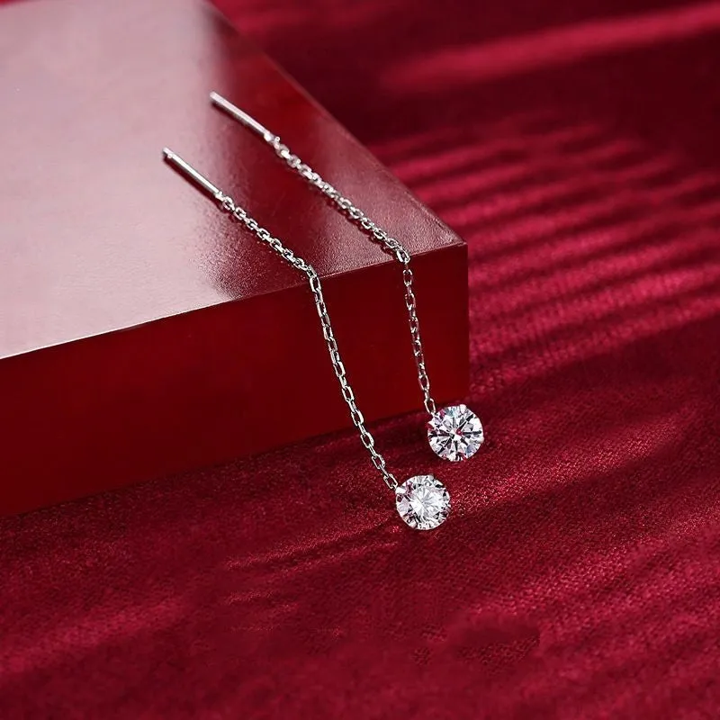Round zirconium stud earrings with tassel rhinestone hanging in white gold colour on a geometric silver base