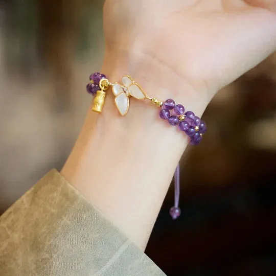 Handmade purple amethyst crystal bracelet with multi-treasure natural stone beads on white background